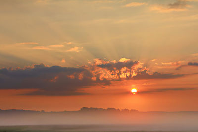 Scenic view of dramatic sky during sunset