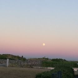 Scenic view of landscape against clear sky during sunset