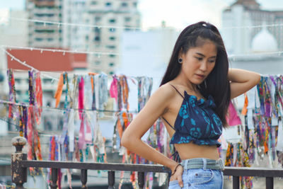 Young woman standing against store