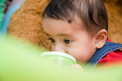 Close-up of boy looking away while drinking water