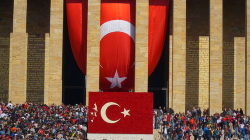 Group of people in front of flags