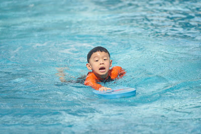 High angle view of boy swimming in sea