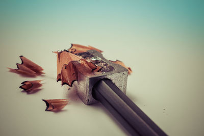 Close-up of pencils on table against white background