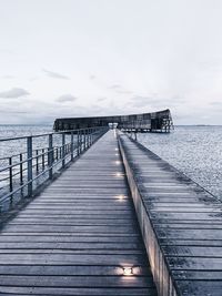 Pier over sea against sky