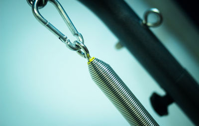 Close-up of metallic equipment against blue wall