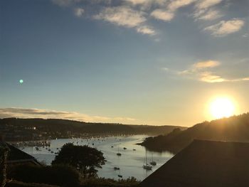 Scenic view of river against sky during sunset