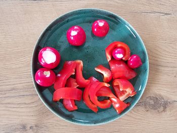 High angle view of red cherries in bowl on table