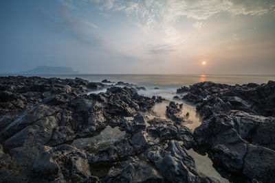 Scenic view of sea against sky during sunrise