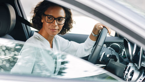 Portrait of woman sitting in car