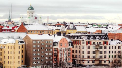 Buildings against cloudy sky