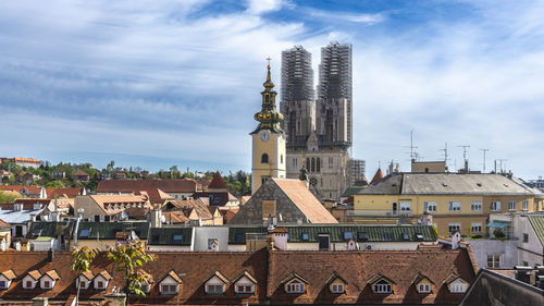 Buildings in city against sky