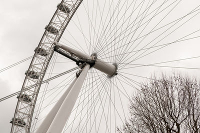 Low angle view of ferris wheel against sky