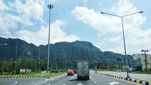 Cars on road against sky