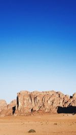 Rock formations in desert against clear blue sky