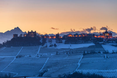 Buildings in city against sky during winter