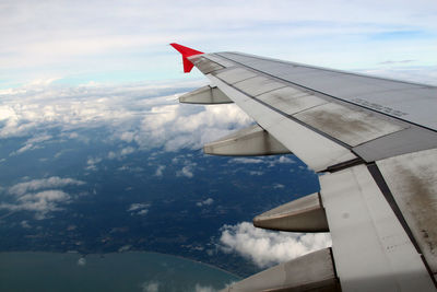 Aerial view of aircraft wing against sky