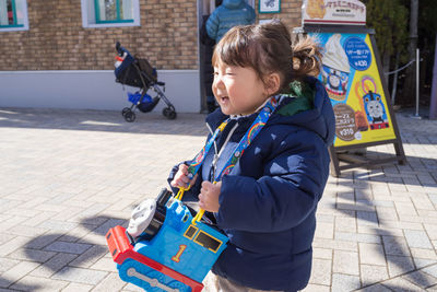 Boy playing with toy in bus