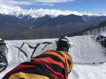 Rear view of person on snowcapped mountain