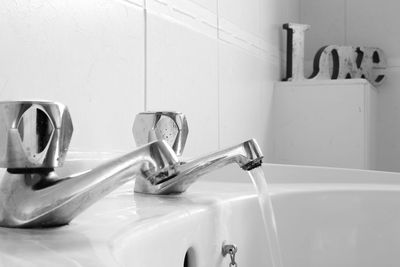 Close-up of faucet in bathroom