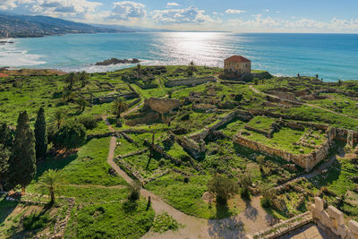 High angle view of land and sea against sky