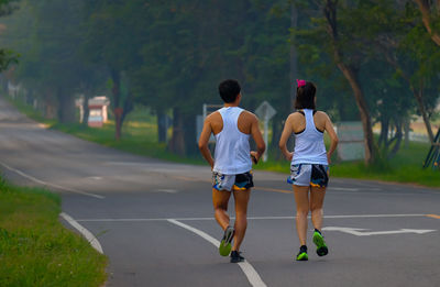 Rear view of people walking on street