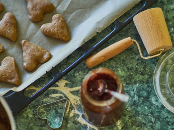 High angle view of preserves by caked pastry item on table