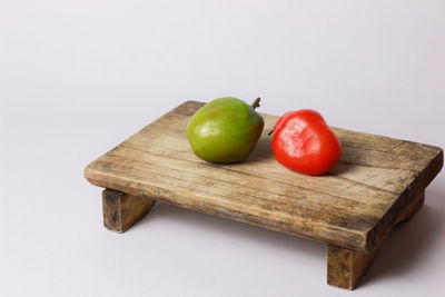 Close-up of fruits on table against white background