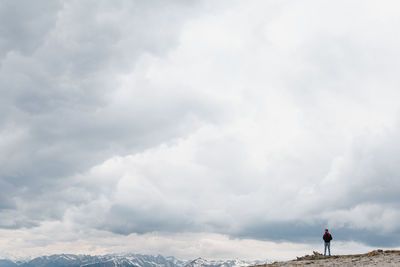 Man on landscape against sky