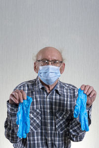 Portrait of man wearing mask against white background