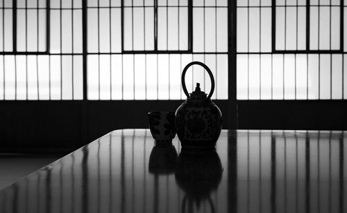 Silhouette of a japanese tea cup and tea kettle in a japanese house.