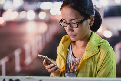 Young woman using mobile phone outdoors