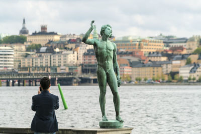 Carl eldh bronze sculpture at stadshuset city hall with tourist image