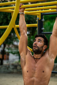 Close-up of young man wearing exercising outdoors