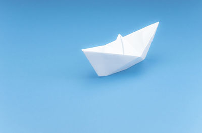 High angle view of paper flag against blue background