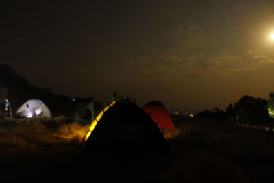 Close-up of illuminated lights against sky at night