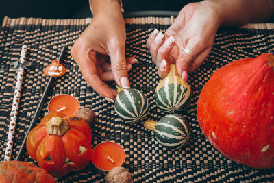 Cropped hand of man holding pumpkin
