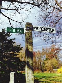 Low angle view of road sign against sky