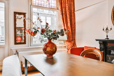 Flower vase on table at home