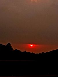 Silhouette landscape against romantic sky at sunset