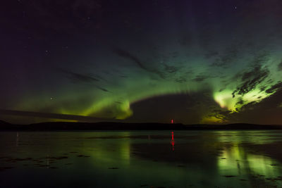 Scenic view of lake against sky at night