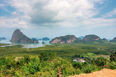 Scenic view of landscape and sea against sky