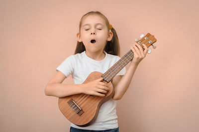 Portrait of boy playing guitar