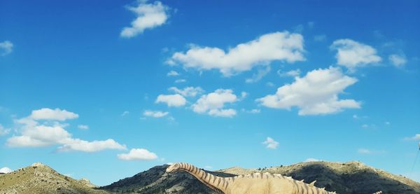 Low angle view of mountain against blue sky