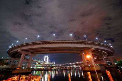 Low angle view of illuminated bridge against sky at night