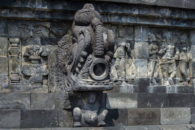 Old statue against wall