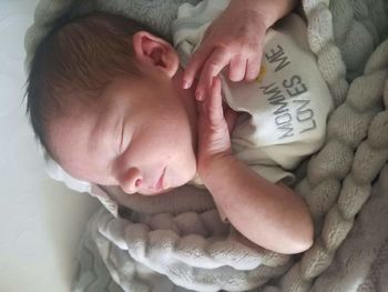 Cute baby girl sleeping on bed at home