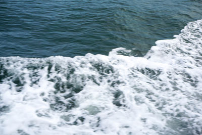 High angle view of waves splashing on sea