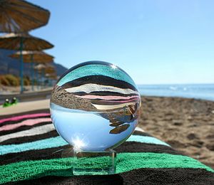 Close-up of drink at beach against blue sky