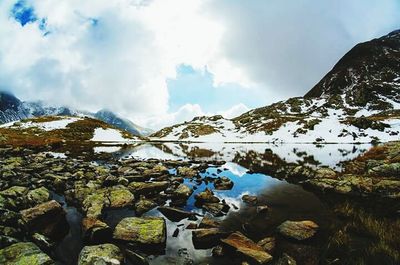 Scenic view of mountains against cloudy sky