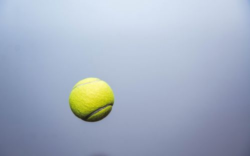 Close-up of tennis ball mid-air